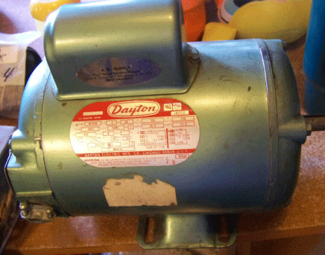 The capacitor is inside the round "bump" on the side of this electric compressor motor - fix-my-compressor.com