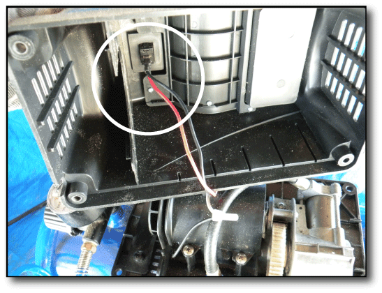 Broken compressor ON OFF switch looking up inside the compressor shroud